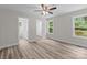 Main bedroom showcasing an ensuite bathroom, walk in closet, windows, and wood-look flooring at 896 Oval St, Kannapolis, NC 28081