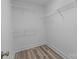 Walk-in closet featuring wire shelving and wood-look vinyl flooring at 896 Oval St, Kannapolis, NC 28081