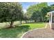 Spacious backyard featuring lush greenery, mature trees, and a stone patio, perfect for outdoor relaxation and entertaining at 9157 Snow Hill Ct, Charlotte, NC 28269