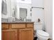 Well-lit bathroom featuring a granite vanity top and ample storage space at 9157 Snow Hill Ct, Charlotte, NC 28269