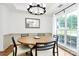 Dining room with a round wood table, stylish chairs, and a large window offering natural light at 9157 Snow Hill Ct, Charlotte, NC 28269