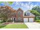 Charming two-story brick home with a landscaped yard and a two-car garage at 9157 Snow Hill Ct, Charlotte, NC 28269