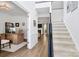 Welcoming foyer featuring hardwood flooring, a staircase, and an adjacent office space at 9157 Snow Hill Ct, Charlotte, NC 28269