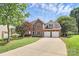 Beautiful two-story brick home with a two-car garage and a long driveway at 9157 Snow Hill Ct, Charlotte, NC 28269
