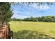 Scenic view of a meticulously maintained golf course with rolling greens and mature trees under a blue sky at 9157 Snow Hill Ct, Charlotte, NC 28269