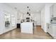 Bright kitchen with center island, stainless steel appliances, white cabinets, and backyard access at 9157 Snow Hill Ct, Charlotte, NC 28269