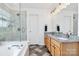 Lovely bathroom with double sink vanity, soaking tub, and glass shower at 9157 Snow Hill Ct, Charlotte, NC 28269