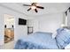 Comfortable main bedroom featuring a tray ceiling, ceiling fan, television, and ensuite at 9157 Snow Hill Ct, Charlotte, NC 28269