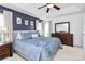 Comfortable main bedroom featuring a tray ceiling, ceiling fan and neutral decor at 9157 Snow Hill Ct, Charlotte, NC 28269