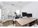 Well-lit office space with modern desk setup and access to an outdoor view at 9157 Snow Hill Ct, Charlotte, NC 28269