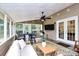 Relaxing sunroom with comfortable seating, a ceiling fan, and an outdoor view, ideal for leisure at 9157 Snow Hill Ct, Charlotte, NC 28269