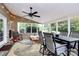 Enclosed sunroom featuring ample seating, a ceiling fan, and views of the outdoors at 9157 Snow Hill Ct, Charlotte, NC 28269