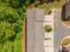 An aerial shot highlights the roofline of a neighborhood townhouse complex surrounded by green trees at 9203 Grand Valley Dr, Charlotte, NC 28213