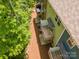 Aerial view of townhome back porches surrounded by green trees, offering a tranquil outdoor space at 9203 Grand Valley Dr, Charlotte, NC 28213