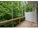 View from a wooden deck surrounded by lush green trees at 9203 Grand Valley Dr, Charlotte, NC 28213