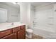 Cozy bathroom featuring a shower-tub combo, single sink vanity, and a well-lit mirror at 9203 Grand Valley Dr, Charlotte, NC 28213