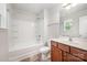 Clean bathroom featuring a shower-tub combo, single sink vanity, and a well-lit mirror at 9203 Grand Valley Dr, Charlotte, NC 28213