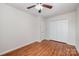 Clean bedroom featuring hardwood floors, closet with doors and a ceiling fan at 9203 Grand Valley Dr, Charlotte, NC 28213