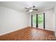 Bright bedroom featuring hardwood floors, a ceiling fan, and natural light from large windows at 9203 Grand Valley Dr, Charlotte, NC 28213