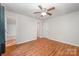 Spacious bedroom featuring wood floors, a ceiling fan, and multiple closets for ample storage at 9203 Grand Valley Dr, Charlotte, NC 28213