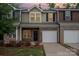 Charming townhouse with brick facade, single car garage and well-maintained landscaping at 9203 Grand Valley Dr, Charlotte, NC 28213