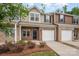 Beautiful townhouse showcasing a brick exterior, private garage, and manicured landscaping at 9203 Grand Valley Dr, Charlotte, NC 28213
