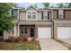Charming townhouse with a brick facade, a one-car garage, and freshly landscaped front yard at 9203 Grand Valley Dr, Charlotte, NC 28213