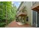 Exterior view of a multi-unit property with wood decks, green siding and landscaped yard at 9203 Grand Valley Dr, Charlotte, NC 28213