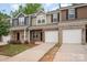 Lovely townhouse with brick and siding exterior, a garage, and attractive landscaping at 9203 Grand Valley Dr, Charlotte, NC 28213
