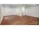 Spacious living room featuring hardwood floors, recessed lighting, and white walls at 9203 Grand Valley Dr, Charlotte, NC 28213