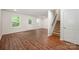 Open living room featuring hardwood floors, a staircase, and a glass back door at 9203 Grand Valley Dr, Charlotte, NC 28213