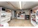 Basement with open shelving, concrete floors, and a doorway to additional space at 1139 S Belvedere Ave, Gastonia, NC 28054