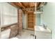 Unfinished bathroom with exposed brick, built-in shelving, and a vintage sink at 1139 S Belvedere Ave, Gastonia, NC 28054