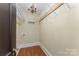 Walk-in closet featuring hardwood floors, hanging racks, and overhead lighting at 1139 S Belvedere Ave, Gastonia, NC 28054