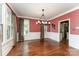 Elegant dining room with wainscoting, hardwood floors, and large windows at 1139 S Belvedere Ave, Gastonia, NC 28054