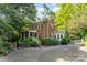 Charming brick home with lush landscaping, inviting porch, and a detached garage at 1139 S Belvedere Ave, Gastonia, NC 28054