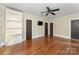 Large living room with a ceiling fan, hardwood flooring, and built-in shelving at 1139 S Belvedere Ave, Gastonia, NC 28054