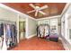 Bright sun room with red brick floors, ample windows, and a ceiling fan for comfort at 1139 S Belvedere Ave, Gastonia, NC 28054