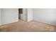 Neutral bedroom features tan carpet, light walls and trim, and a closet at 11530 Galashiels Dr, Huntersville, NC 28078