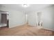 Bedroom with neutral carpet and white walls and trim, showing an open ensuite bathroom at 11530 Galashiels Dr, Huntersville, NC 28078
