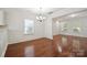 Bright dining room featuring hardwood floors, white molding and a modern chandelier at 11530 Galashiels Dr, Huntersville, NC 28078