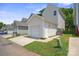 Exterior of garage with white door, siding, concrete driveway, and green lawn at 11530 Galashiels Dr, Huntersville, NC 28078