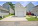 Exterior of garage with white door, siding, concrete driveway, and green lawn at 11530 Galashiels Dr, Huntersville, NC 28078