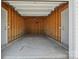 Empty one-car garage with wood stud walls and concrete floor with two doors at 11530 Galashiels Dr, Huntersville, NC 28078