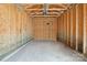 Clean, unfinished interior of garage with concrete floor and exposed wood frame at 11530 Galashiels Dr, Huntersville, NC 28078