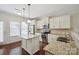 Modern kitchen with stainless steel appliances, granite countertops, and hardwood floors at 11530 Galashiels Dr, Huntersville, NC 28078