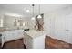 Stylish kitchen with stainless appliances, a large granite island, and hardwood floors at 11530 Galashiels Dr, Huntersville, NC 28078