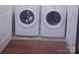 Bright laundry room with a side-by-side washer and dryer and light wood-look flooring at 11530 Galashiels Dr, Huntersville, NC 28078