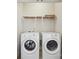 Laundry room features a pair of white front-loading washing machines and wire shelving at 11530 Galashiels Dr, Huntersville, NC 28078