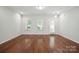 Spacious living room with hardwood floors and lots of natural light from the windows at 11530 Galashiels Dr, Huntersville, NC 28078